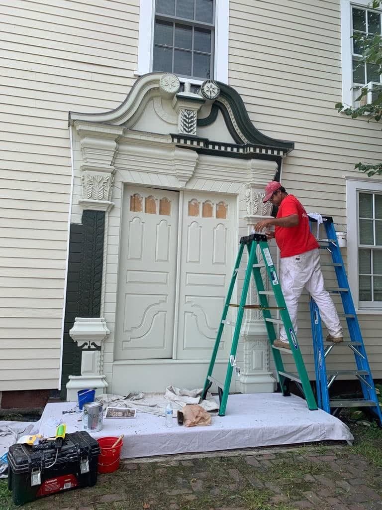 J Painting Service professional painter restoring an exterior entryway
